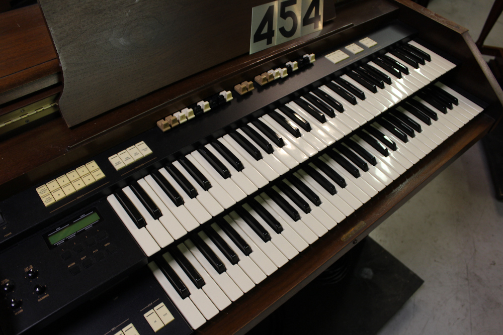 454 is a Hammond A-205 in a walnut finish equipped with a transposer, built-in speakers, and has an output for MIDI! Serial #01010285