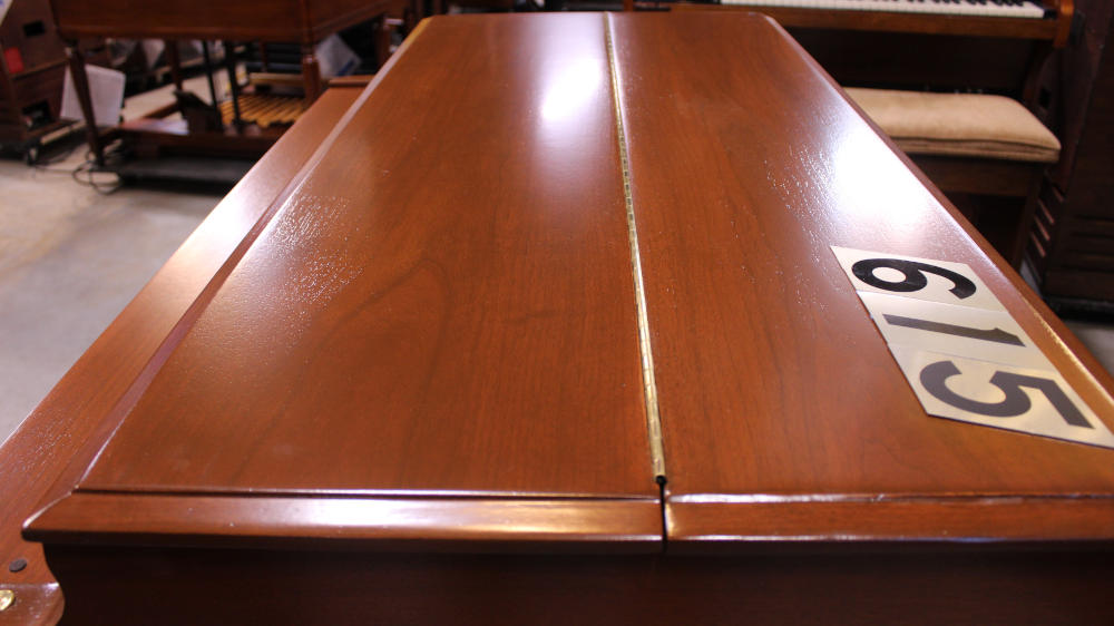 615 is a 1952 Hammond B2 converted to a B3 in a walnut finish.  Serial #45915